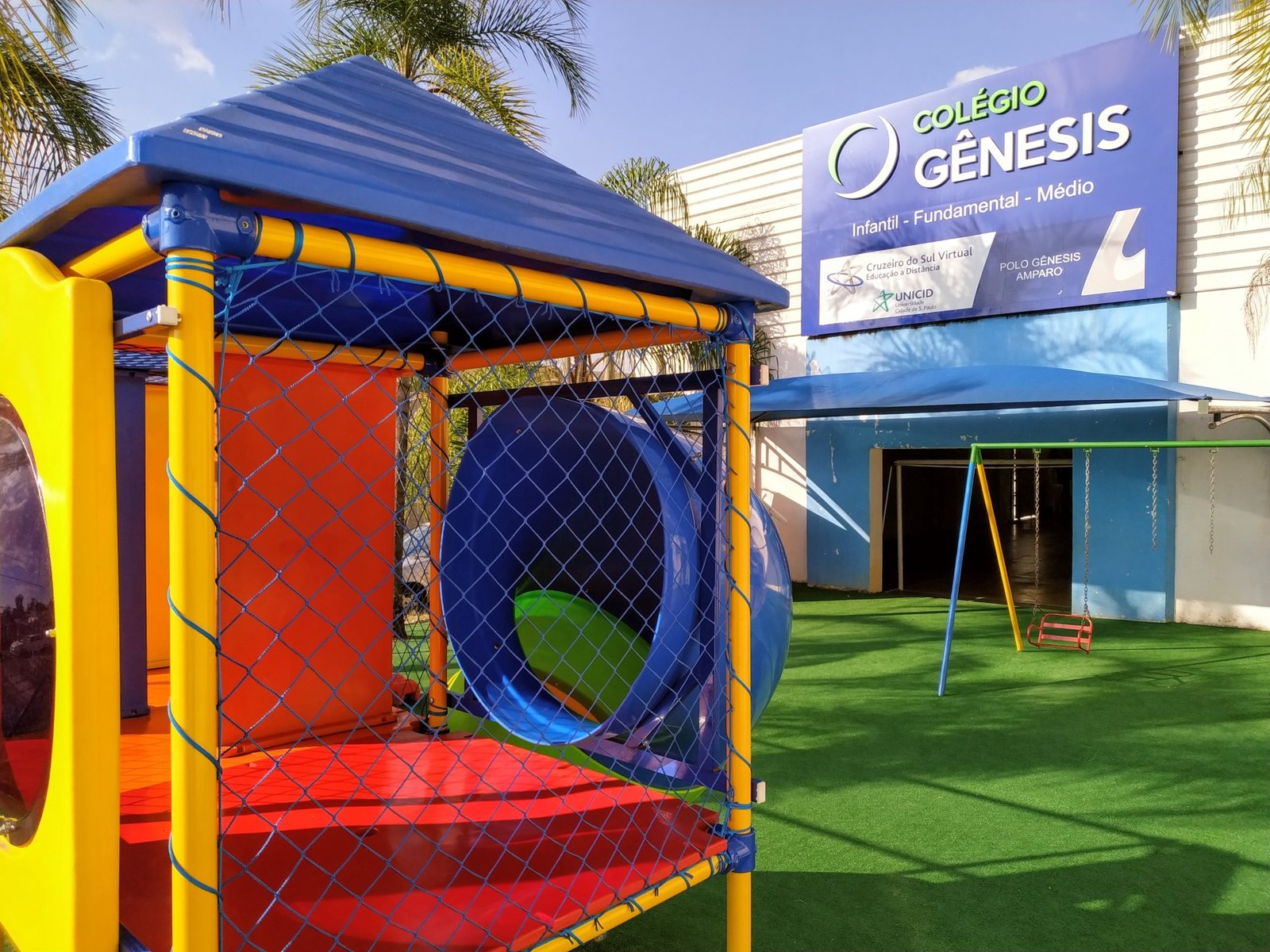 Playground do Colégio Gênesis com brinquedos e área de recreação